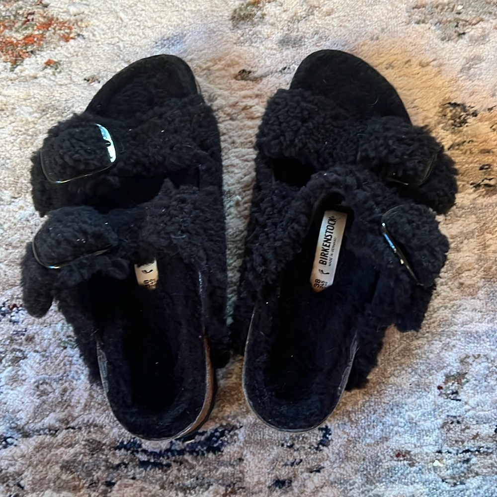 Birkenstock big buckle Arizona teddy sandals.